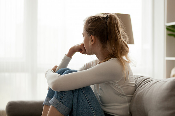Young Woman Thinking on Couch